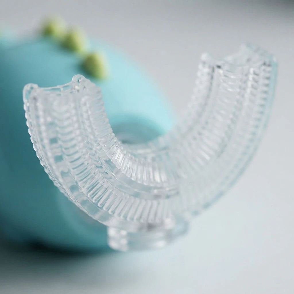 Cepillo de dientes eléctrico infantil Rexi en forma de U con carcasa de dinosaurio